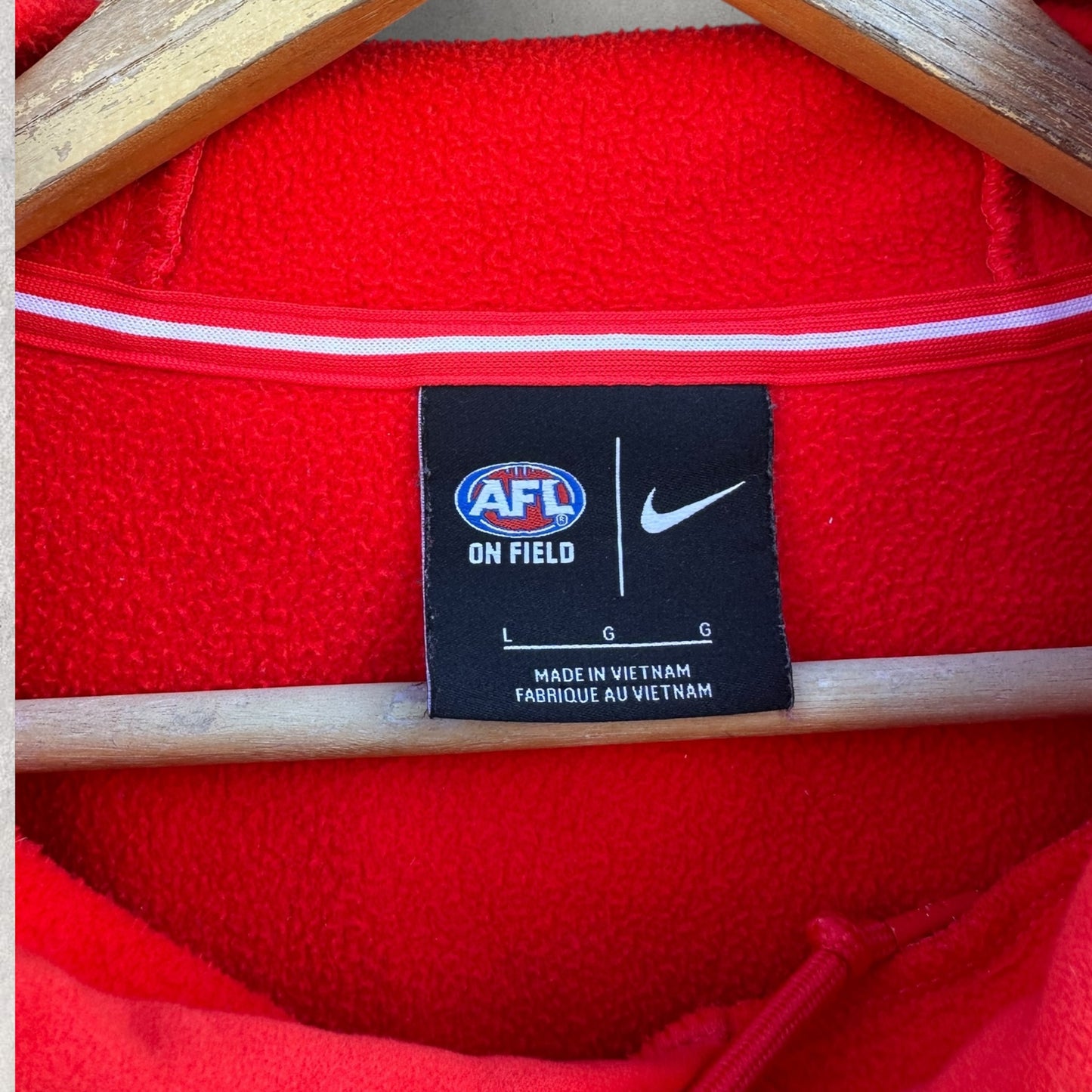 SYDNEY SWANS NIKE ON FIELD RED HOODED JUMPER